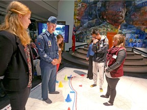 Army Cadet Warrant Officer 2nd Class Michael Batas speaks as he and a group walk on a floor map of Vimy Ridge during a launch event for the Spirit of Vimy program in Calgary, Alta on Thursday September 22, 2016. The education initiative was created by the Honourable Lois Mitchell and the Spirit of Vimy will foster greater awareness of, and appreciation of Canadian soldiers during the pivotol battle. Jim Wells/Postmedia