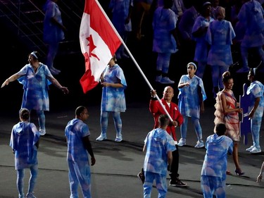 Wheelchair basketball player David Eng, carries the Canadain flag into the opening ceremonies of the Rio Paralympics in Rio De Janerio, Brazil  on Tuesday September 6, 2016. Leah hennel/Postmedia