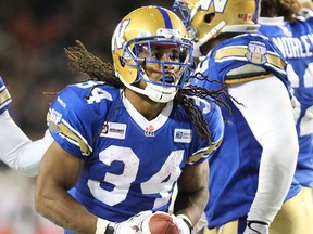 Winnipeg Blue Bomber RB Paris Cotton celebrates his touchdown run against the B.C. Lions during CFL action at Investors Group Field in Winnipeg, Man., on Sat., Oct. 25, 2014. Kevin King/Winnipeg Sun/QMI Agency