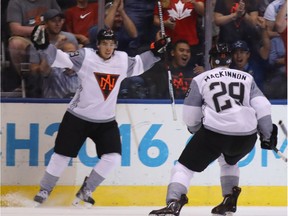 Johnny Gaudreau #13 and Nathan MacKinnon #29 of Team North America celebrate Gaudreau's first period goal against Team Sweden at the World Cup of Hockey tournament at the Air Canada Centre on September 21, 2016 in Toronto, Canada.
