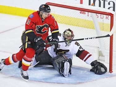 The Calgary Flames' Mikael Backlund races past Arizona Coyotes goaltender Mike Smith chasing a loose puck during the second period of their NHL preseason game at the Scotiabank Saddledome in Calgary, Wednesday Oct. 5, 2016.