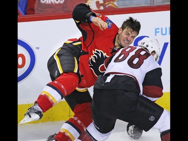 The Arizona Coyotes' Jamie McGinn and Calgary Flames forward Lance Bouma fight during the second period of their NHL preseason game at the Scotiabank Saddledome in Calgary, Wednesday Oct. 5, 2016.
