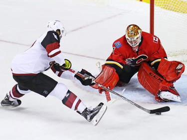 Calgary Flames goaltender Brian Elliott stops the Arizona Coyotes'  Anthony Duclair during the shoot out in their NHL  preseason game at the Scotiabank Saddledome in Calgary, Wednesday Oct. 5, 2016. Calgary won the game 2-1.