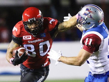 Calgary Stampeders wide receiver Jamal Nixon looks to avoid Montreal Alouettes linebacker Chip Cox during CFL action at McMahon Stadium in Calgary on Saturday October 15, 2016. Gavin Young/Postmedia