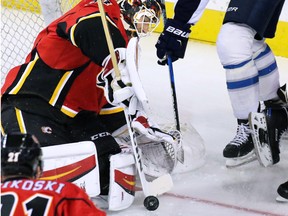 Calgary Flames goaltender Chad Johnson stops this shot from the Winnipeg Jets' Andrew Copp during NHL preseason action in Calgary on Sunday Oct. 2, 2016.