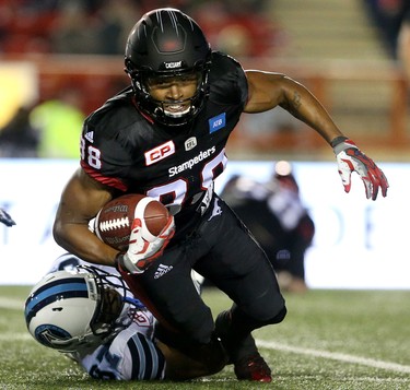 Calgary Stampeders Kamar Jorden is tackled by Toronto Argonauts Marcus Alford in CFL action at McMahon Stadium in Calgary, Alta.. on Friday October 21, 2016.
