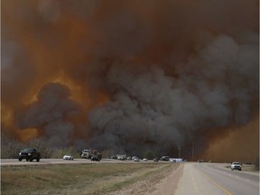 Residents of Fort McMurray flee southbound on Highway 63 Tuesday. Wildfires forced the evacuation of the city Tuesday as high temperatures and winds continued to batter the region. Robert Murray/Fort McMurray Today/Postmedia Network ORG XMIT: POS1605032035462206