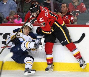 Calgary Flames Matthew Tkachuk, right, collides with Buffalo Sabres Tyler Ennis in NHL hockey action at the Scotiabank Saddledome in Calgary, Alta. on Tuesday October 18, 2016. Leah Hennel/Postmedia