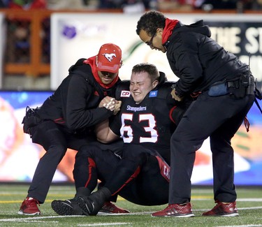 Calgary Stampeders Pierre Lavertu is helped off the field during their game against Toronto Argonauts in CFL action at McMahon Stadium in Calgary, Alta.. on Friday October 21, 2016.
