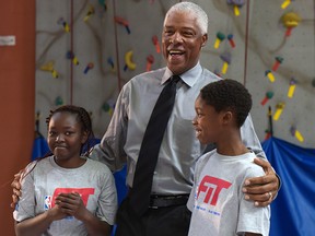 Julius 'Dr. J' Erving (centre) was at the Boys and Girls Club of Calgary to celebrate the completion of a newly refurbished basketball court on Monday, Oct. 3, 2016. Here, the NBA legend shares a laugh with Alek Duans and Daniel Ajayi, two youth representatives from the club. Elizabeth Cameron/Postmedia