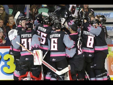 Calgary Hitmen mob Jordy Stallard after his goal won the game for the Hitmen in WHL action at the Scotiabank Saddledome in Calgary, Alberta, on Saturday, October 29. The Hitmen beat the Cougars in overtime 3-2. Mike Drew/Postmedia