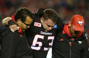 Calgary Stampeders Pierre Lavertu is helped off the field during their game against Toronto Argonauts in CFL action at McMahon Stadium in Calgary, Alta.. on Friday October 21, 2016. Leah hennel/Postmedia