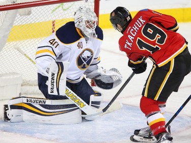 Calgary Flames Matthew Tkachuk, right, tries to score on Buffalo Sabres Robin Lehner in NHL hockey action at the Scotiabank Saddledome in Calgary, Alta. on Tuesday October 18, 2016. Leah Hennel/Postmedia