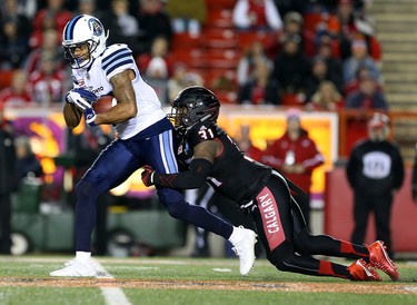 Calgary Stampeders Jamar Wall, right, tackles  Toronto Argonauts DeVier Posey in CFL action at McMahon Stadium in Calgary, Alta.. on Friday October 21, 2016.