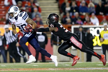 Calgary Stampeders Jamar Wall, right, tackles  Toronto Argonauts DeVier Posey in CFL action at McMahon Stadium in Calgary, Alta.. on Friday October 21, 2016.