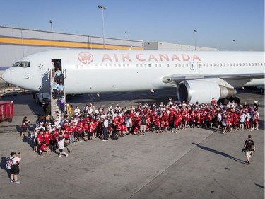 A group of Dreams Take Flight kids pose for a photo iwth their Air Canada Boeing 767 after landing LAX in Los Angeles, California, on Wednesday, Oct. 19, 2016. Dreams Take Fight Calgary took 150 kids deserving a break from difficult situations for a one-day trip to the Magical Kingdom. It was Air Canada's 24th year for its charity event. Lyle Aspinall/Postmedia Network