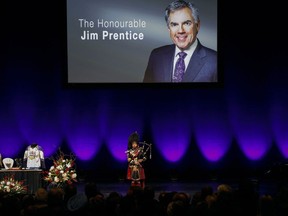 A lone piper plays at a memorial service for former Alberta Premier Jim Prentice in Calgary on Friday, October 28, 2016. Prentice was killed in a plane crash in B.C. on Oct. 13.
