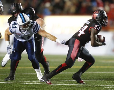 Calgary Stampeders Tory Harrison avoids a tackle by Kyler Elsworth of the Toronto Argonauts during CFL football in Calgary, Alta., on Friday, October 21, 2016.