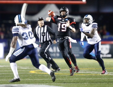 Calgary Stampeders Bo Levi Mitchell scrambles under pressure from the Toronto Argonauts defence during CFL football in Calgary, Alta., on Friday, October 21, 2016.