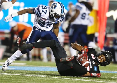 Calgary Stampeders Kamar Jorden with a catch in front of Marcus Alford of the Toronto Argonauts during CFL football in Calgary, Alta., on Friday, October 21, 2016.