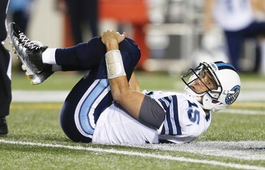 Toronto Argonauts Ricky Ray after being knocked to the turf by Charleston Hughes of the Calgary Stampeders during CFL football in Calgary, Alta., on Friday, October 21, 2016.