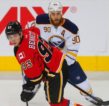 Calgary Flames Sam Bennett battle for a loose puck against Ryan O'Reilly of the Buffalo Sabres during NHL hockey in Calgary, Alta. on Tuesday October 18, 2016. Al Charest/Postmedia