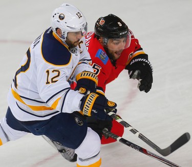 The captains, Brian Gionta of the Buffalo Sabres and Mark Giordano of the Calgary Flames during NHL hockey in Calgary, Alta., on Tuesday, October 18, 2016.