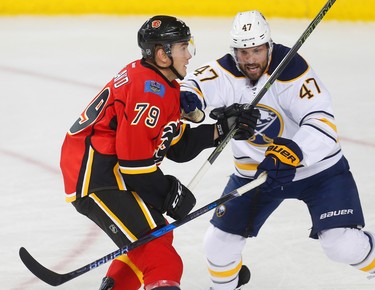 Calgary Flames Micheal Ferland battles against Zach Bogosian of the Buffalo Sabres during NHL hockey in Calgary, Alta., on Tuesday, October 18, 2016. AL CHAREST/POSTMEDIA