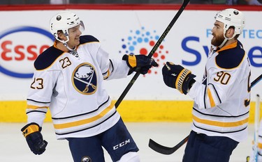 Buffalo Sabres Sam Reinhart and Ryan O'Reilly celebrate after their teams second goal against the Calgary Flames during NHL hockey in Calgary, Alta., on Tuesday, October 18, 2016. AL CHAREST/POSTMEDIA