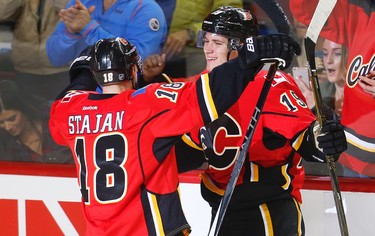 Calgary Flames Matthew Tkachuk celebrates with teammate Matt Stajan after scoring his first NHL goal on Buffalo Sabres goalie Robin Lehner during NHL hockey in Calgary, Alta., on Tuesday, October 18, 2016.