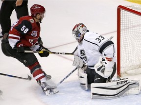 Arizona Coyotes' Michael Bunting (58) gets the puck past Los Angeles Kings' Tom McCollum (33) for a goal during the third period of a preseason NHL hockey game Monday, Sept. 26, 2016, in Glendale, Ariz. The Coyotes defeated the Kings 5-3.