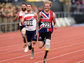 LONDON, ENGLAND - SEPTEMBER 11:  Alex Tate of Great Britain runs to victory in the men's 100m Ambulant IT1 during Day One of the Invictus Games at Lee Valley Athletics Stadium on September 11, 2014 in London, England.  (Photo by Ben Hoskins/Getty Images for Invictus Games)