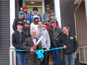 Avi Amir, founder and chairman of Homes by Avi, prepares to cut the ribbon on a house in the northeast Calgary community of Savanna in Saddle Ridge. Construction students from Jack James High School helped build the main floor.