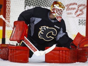 Calgary Flames goalie Brian Elliott makes a save during an on-ice session on the second day of training camp in Calgary, Friday, Sept. 23, 2016.Acquired in a draft-day deal for a second-round and a conditional pick, the 31-year-old from Newmarket, Ont., and free-agent signing Chad Johnson were the off-season solutions to Calgary's goaltending woes.