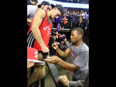 The Toronto Raptors' Kyle Lowry signs autographs for fans before the NBA preseason game against the Denver Nuggets at the Scotiabank Saddledome in Calgary on Monday Oct. 3, 2016.