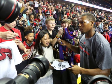 The Toronto Raptors' Kyle Lowry signs autographs for fans before the NBA preseason game against the Denver Nuggets at the Scotiabank Saddledome in Calgary on Monday Oct. 3, 2016.