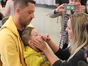 Scott Miranda holds his son Holden, 4, while he gets a  nasal spray flu vaccine during a flu clinic at the South Calgary Health Centre on Monday 24, 2016.  GAVIN YOUNG/POSTMEDIA