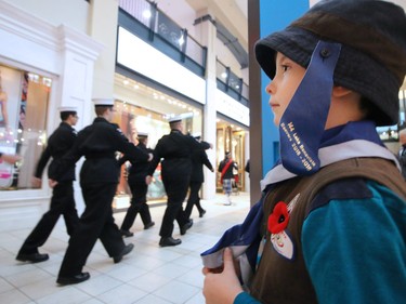 Evan Murphy, with the 144 Lake Bonevista Beavers, watches the colour parade at the launch of the annual Calgary Poppy Fund campaign at  Chinook Centre on Saturday October 29, 2016.