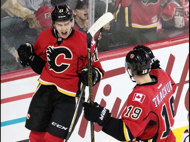 Calgary Flames forward Mikael Backlund, left and Matthew Tkkachuk celebrate scoring on the Washington Capitals during NHL action at the Scotiabank Saddledome in Calgary on Sunday October 30, 2016. It was Backlund's first goal of the season.