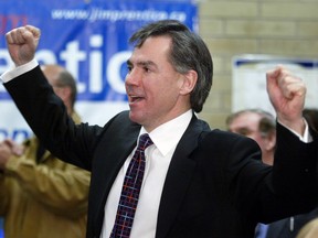 Conservative candidate Jim Prentice celebrates as his party moves ahead of the Liberals in the early going of the national election.