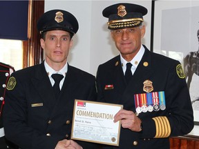 Calgary Firefighter Benoit St. Pierre (L) poses with Fire Chief Steve Dongworth in Calgary, Alta on Thursday October 20, 2016. St. Pierre received one of two Medal of Bravery/ Commendations at the Calgary Fire Dpt's Recognition Awards Luncheon. Twenty-seven Calgarians were honoured for their bravery and decisive actions at a recognition luncheon hosted by the CFD. Fire Chief Steve Dongworth awarded the courageous recipients with medals or certificates of Appreciation, Recognition or Commendation. The recipients were nominated by citizens and members of the Fire Department for their contribution during incidents in the last two years. Jim Wells//Postmedia
