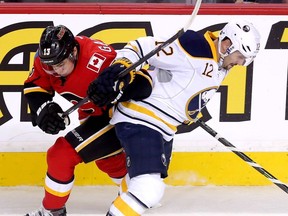Calgary Flames Johnny Gaudreau battles Buffalo Sabres Brian Gionta in first period NHL action at the Scotiabank Saddledome in Calgary on Thursday December 10, 2015.