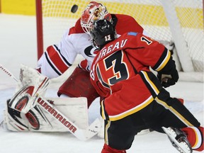 Calgary Flames Johnny Gaudreau lets a shot go against Eddie Lack of the Carolina Hurricanes during NHL hockey in Calgary, Alta., on February 3, 2016.