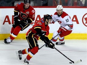 Calgary Flames Johnny Gaudreau skates the puck up the ice against the Carolina Hurricanes during NHL hockey in Calgary, Alta., on Wednesday, February 3, 2016. Al Charest/Postmedia