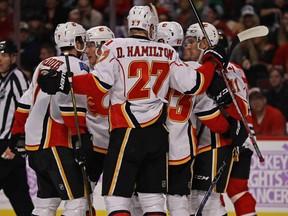 CHICAGO, IL - OCTOBER 24: Members of the Calgary Flames including TJ Brodie #7, Dougie Hamilton #27 and Sam Bennett #93 celebrate Bennett's first period goal against the Chicago Blackhawks at the United Center on October 24, 2016 in Chicago, Illinois.