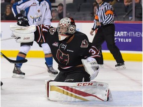 Calgary Hitmen goaltender Cody Porter smacks the puck away during the regular season home opener against the Kootenay Ice at the Scotiabank Saddledome in Calgary, Alta., on Friday, Sept. 23, 2016.