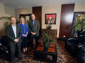 Ken Rigel, left and Terry Moore stand with Ashley Murphy in the lobby of Five West Tower the trio have teamed up to start a new company called Moore Suites.
