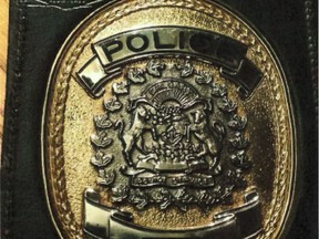 Calgary police have released CCTV footage of two suspects sought in a break-in. A retired officer's badge and 13 guns were stolen on Sept. 14, 2016. Police Handout/Postmedia