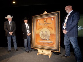Nanton artist Shannon Lawlor stands between Dave Sibbald, right, incoming president, and Dana Peers of the Stampede board, after her piece was unveiled as the 2017 Calgary Stampede poster Wednesday evening October 26, 2016 during the Stampede Report to the Community event at the Lazy S restaurant.