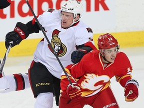 Ottawa Senators Dion Phaneuf battles against Johnny Gaudreau of the Calgary Flames during NHL hockey in Calgary, Alta., on Saturday, February 27, 2016.
